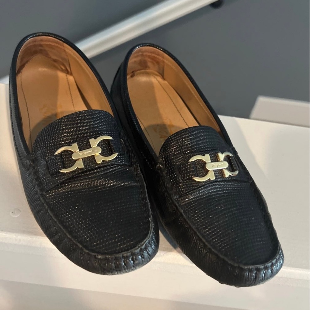 Black with gold hardware ferragamo loafers. Size 6. Few flaws. Worn many times